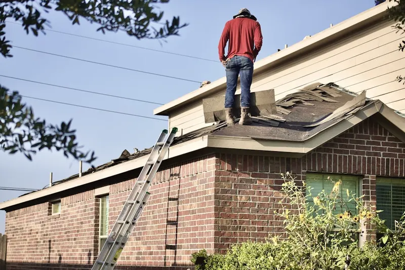 Professional roofer working on a residential roof in Roslyn Estates